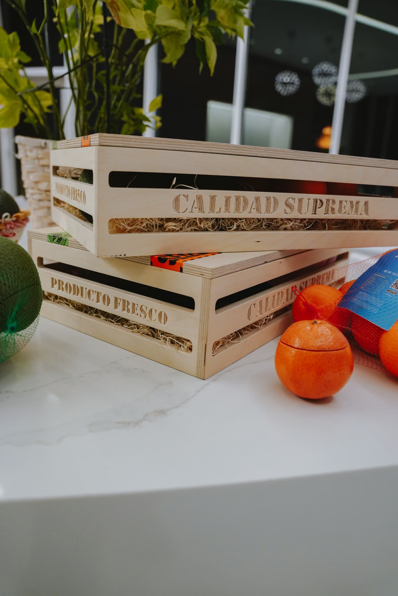 Close low-angle detail of stacked crate sides and a ceramic orange prop on marble